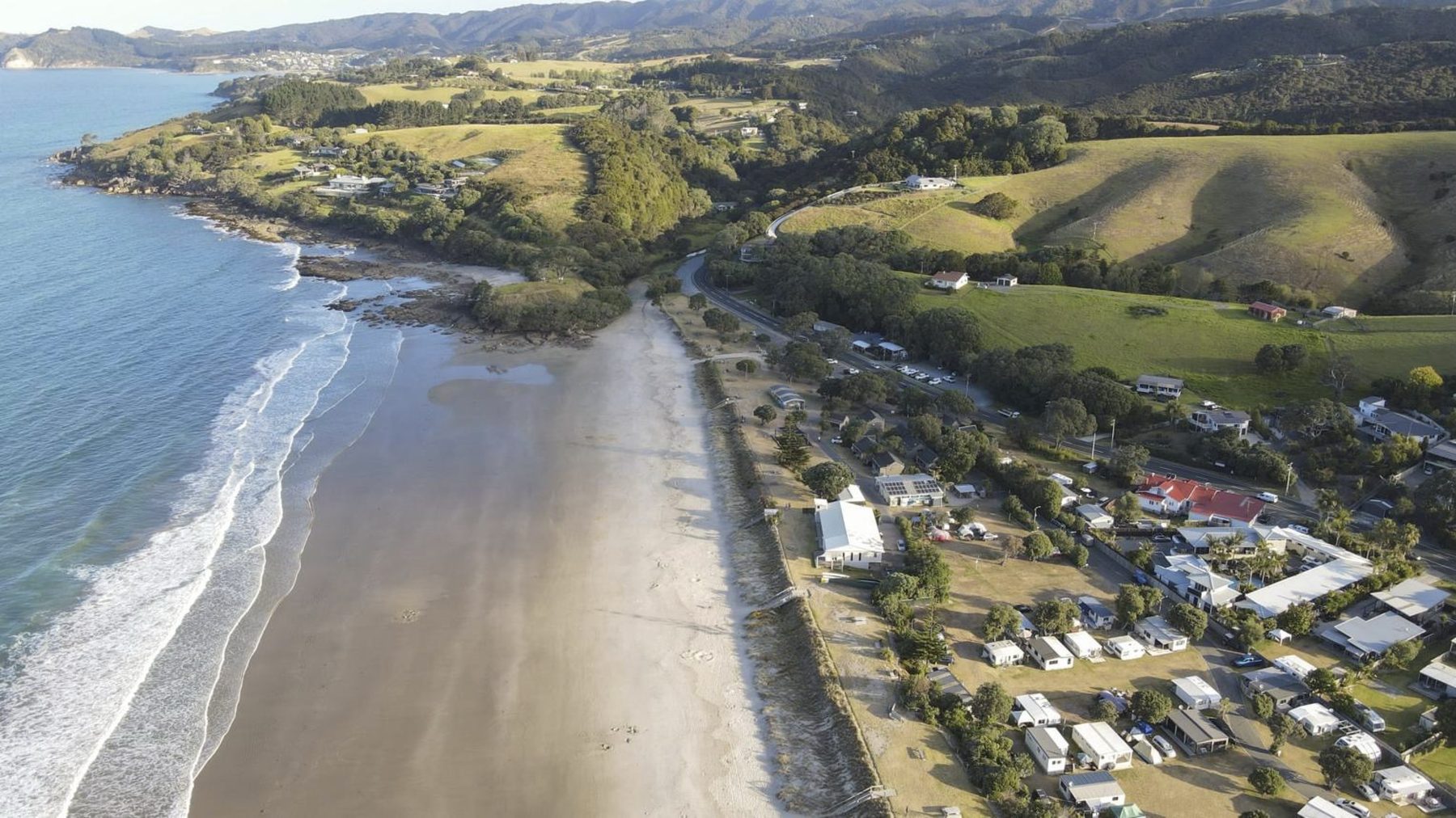 Aerial view of Waipu Cove beach and campground